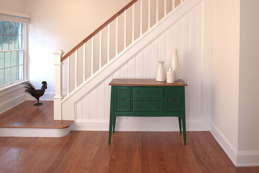 Photo of a mid-sized traditional foyer in New York with white walls and medium hardwood floors.