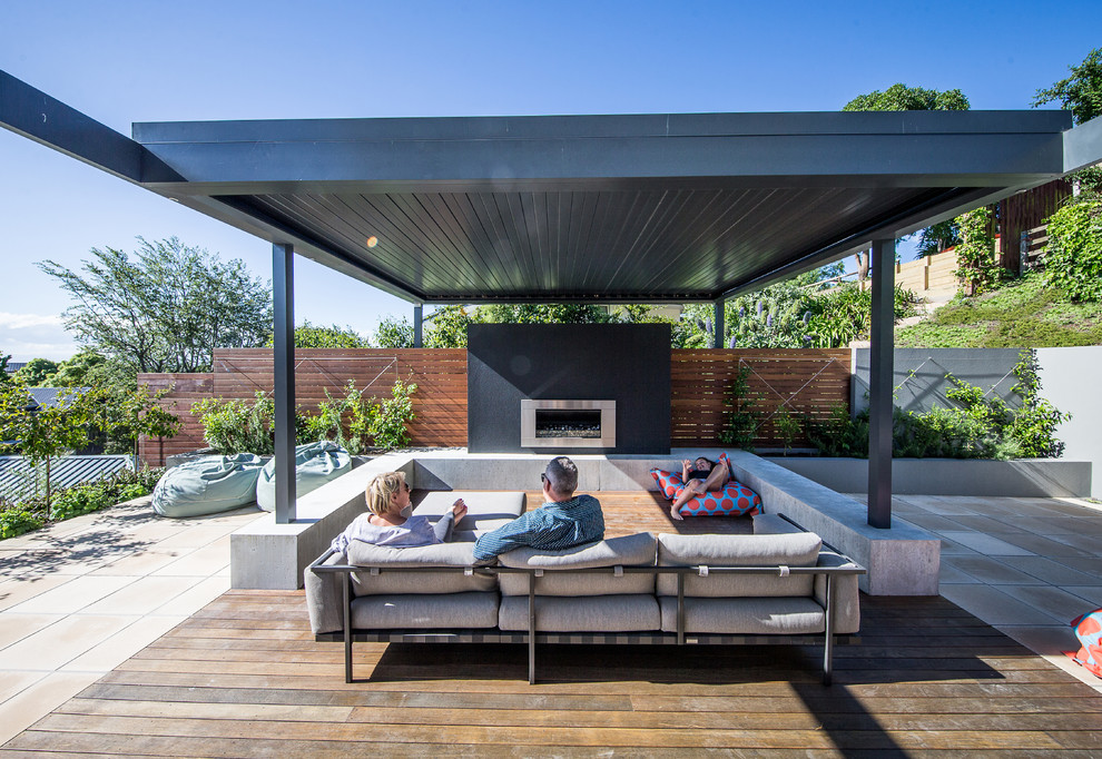 Design ideas for a modern backyard deck in Christchurch with with fireplace.