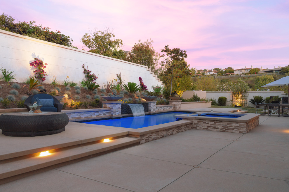 Inspiration for a mediterranean backyard rectangular pool in Los Angeles with a hot tub and concrete slab.