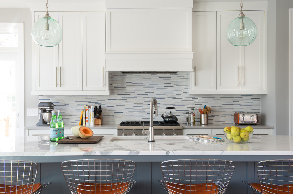 Kitchen - mid-sized transitional galley kitchen idea in Minneapolis with an undermount sink, shaker cabinets, white cabinets, multicolored backsplash, matchstick tile backsplash, gray walls and an island