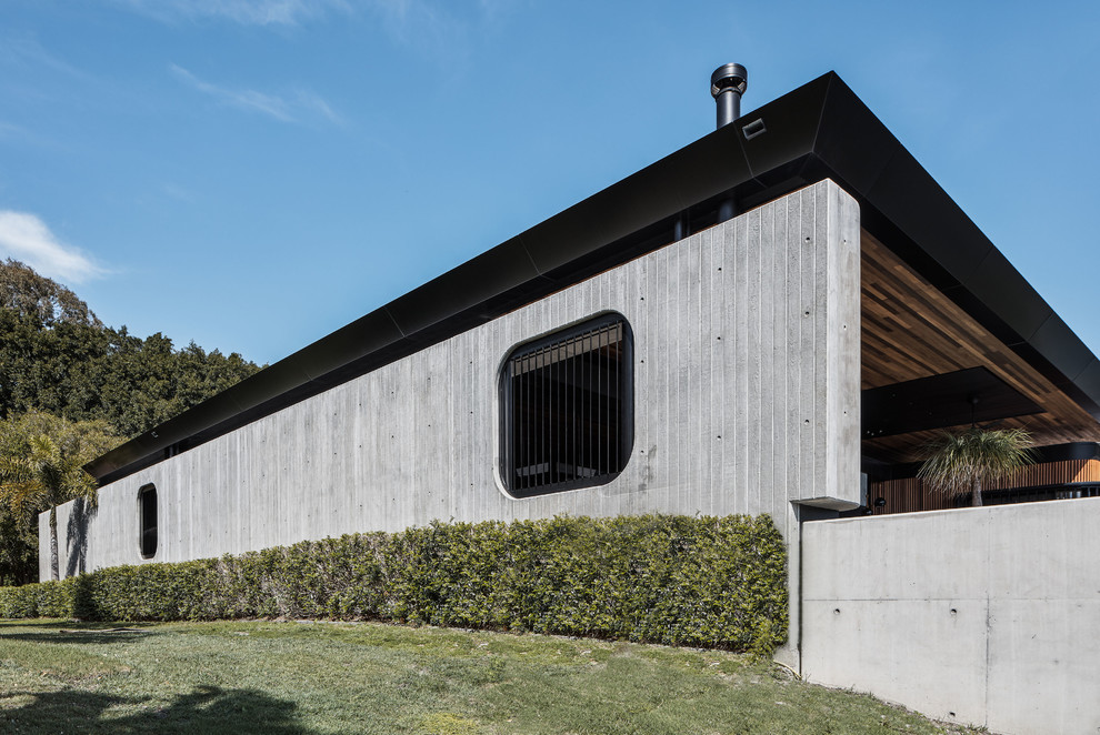 This is an example of an industrial concrete grey house exterior with a shed roof.