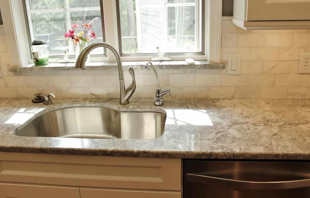 Enclosed kitchen - mid-sized transitional galley medium tone wood floor enclosed kitchen idea in Boston with an undermount sink, beaded inset cabinets, white cabinets, marble countertops, white backsplash, stone tile backsplash, stainless steel appliances and an island