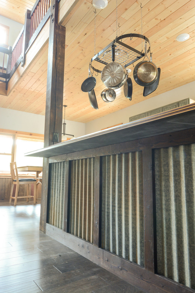 Mid-sized mountain style l-shaped dark wood floor open concept kitchen photo with a double-bowl sink, beaded inset cabinets, distressed cabinets, laminate countertops, stainless steel appliances and an island