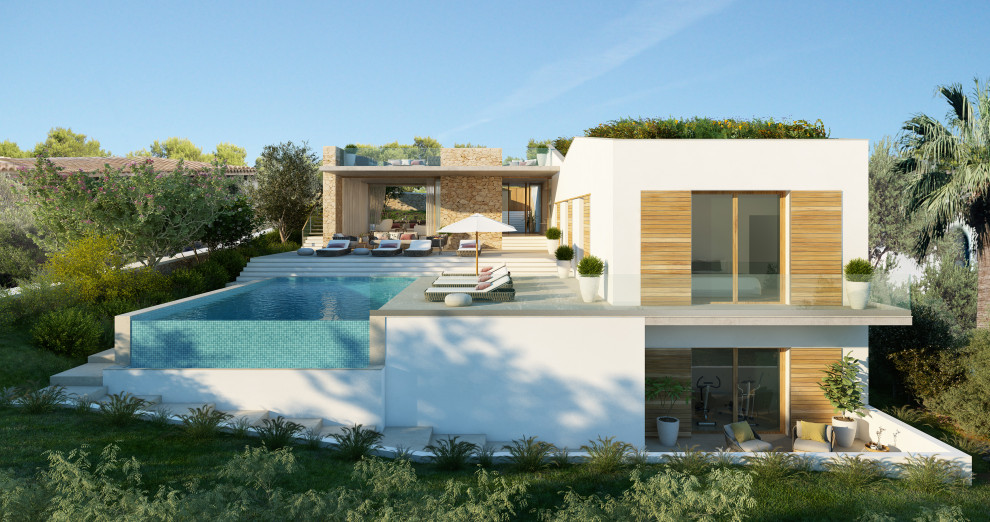 На фото: большой, двухэтажный, белый частный загородный дом в средиземноморском стиле с облицовкой из ЦСП, двускатной крышей и зеленой крышей