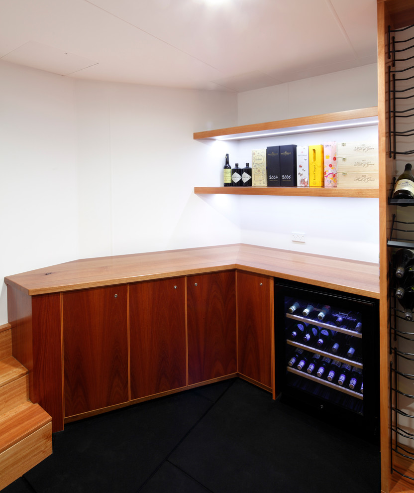 Photo of a contemporary wine cellar in Sydney with black floor.