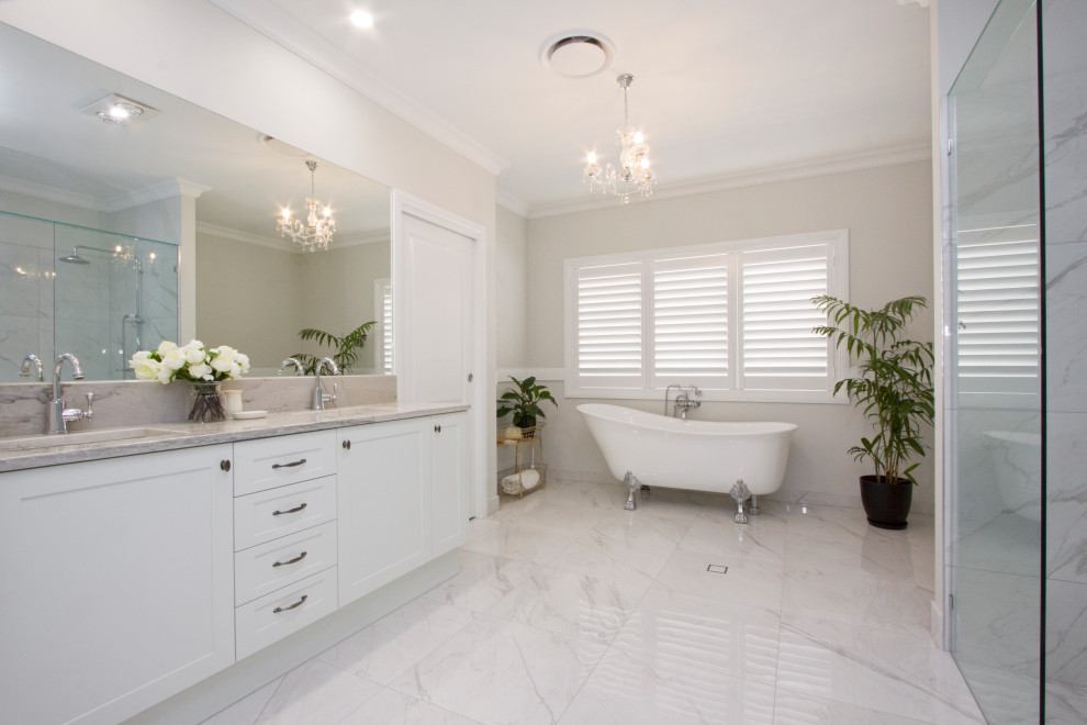 Photo of a small traditional bathroom in Sunshine Coast with shaker cabinets, white cabinets, white tile, subway tile, porcelain floors, an undermount sink, quartzite benchtops and a hinged shower door.