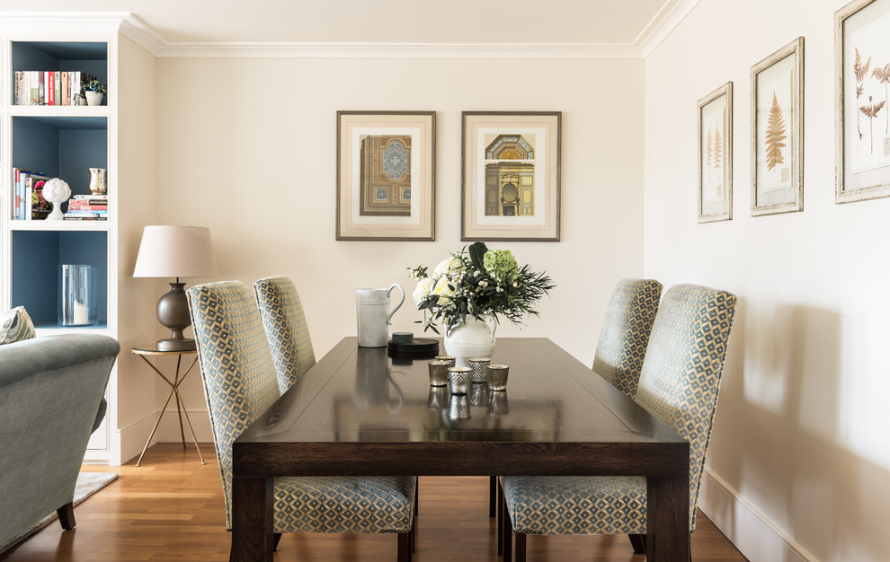 Photo of a mid-sized transitional open plan dining in London with beige walls and light hardwood floors.