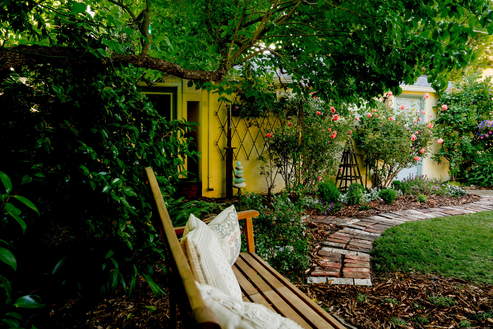 Shaded Garden Path with Bench and Layered Plantings