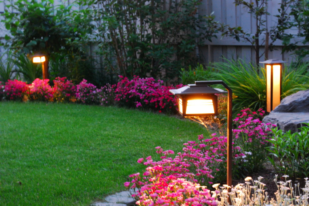 This is an example of a mid-sized rustic backyard concrete paver landscaping in Calgary.