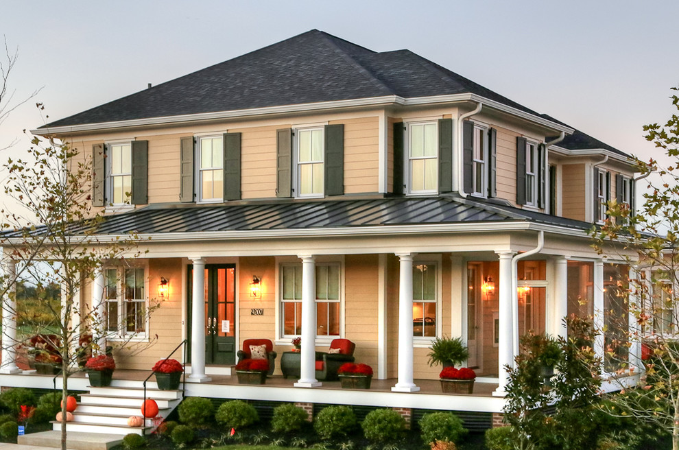 Inspiration for a mid-sized traditional two-storey exterior in Louisville with wood siding and a mixed roof.