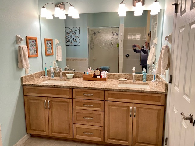 Example of a mid-sized master double-sink bathroom design with raised-panel cabinets, light wood cabinets, laminate countertops, beige countertops and a built-in vanity