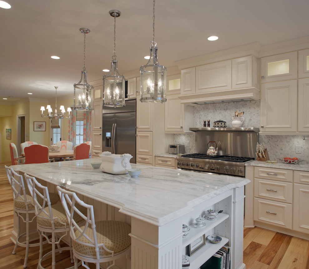 Photo of a large contemporary l-shaped eat-in kitchen in Charleston with an undermount sink, louvered cabinets, white cabinets, granite benchtops, grey splashback, mosaic tile splashback, stainless steel appliances, medium hardwood floors and with island.