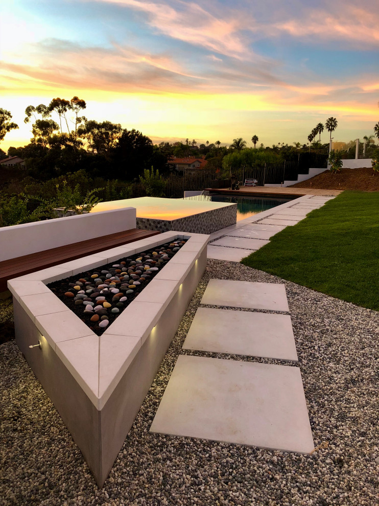 Design ideas for a large midcentury backyard patio in San Diego with a fire feature, concrete pavers and no cover.