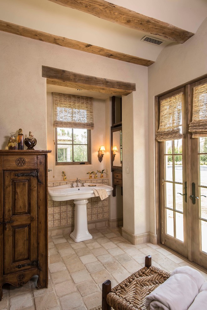 Large country master bathroom in Phoenix with glass-front cabinets, dark wood cabinets, a freestanding tub, a corner shower, a one-piece toilet, beige tile, terra-cotta tile, beige walls, terra-cotta floors, a drop-in sink and wood benchtops.