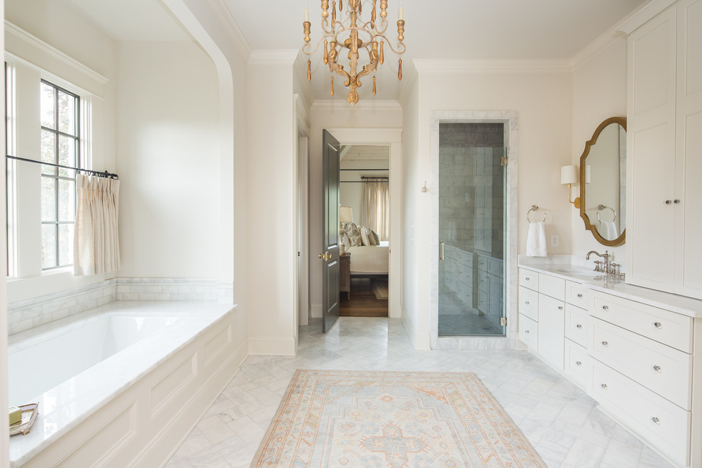 Country bathroom in Atlanta with shaker cabinets, beige cabinets, an undermount tub, an alcove shower, white tile, white walls, an undermount sink, white floor, a hinged shower door and white benchtops.