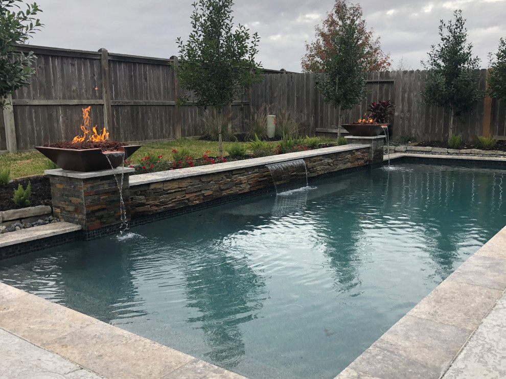 Photo of a mid-sized eclectic backyard natural pool in Houston with with a pool and concrete slab.
