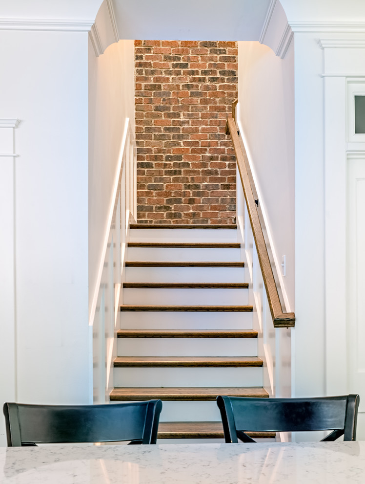 This is an example of a mid-sized traditional wood l-shaped staircase in Nashville with painted wood risers.