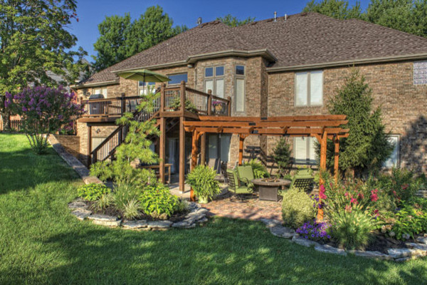 Photo of a mid-sized transitional full sun backyard landscaping for spring.