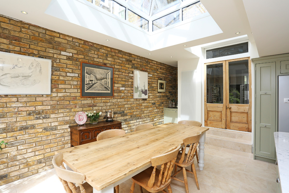 Inspiration for a mid-sized country kitchen/dining combo in London with terra-cotta floors, beige floor and brown walls.