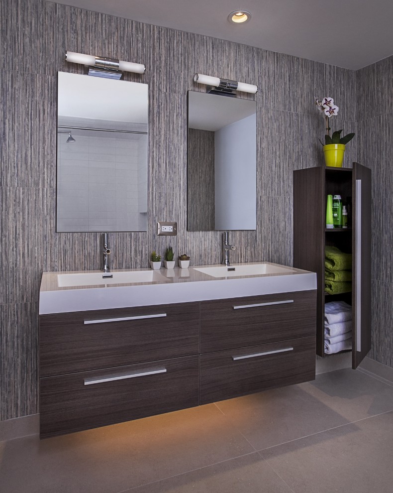 Photo of a mid-sized contemporary bathroom in Detroit with flat-panel cabinets, grey cabinets, an alcove shower, grey walls, an integrated sink, solid surface benchtops, white tile and subway tile.