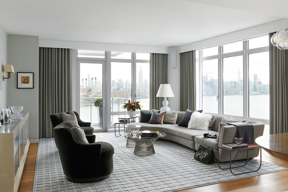 Design ideas for a large contemporary formal living room in New York with grey walls, light hardwood floors and no fireplace.