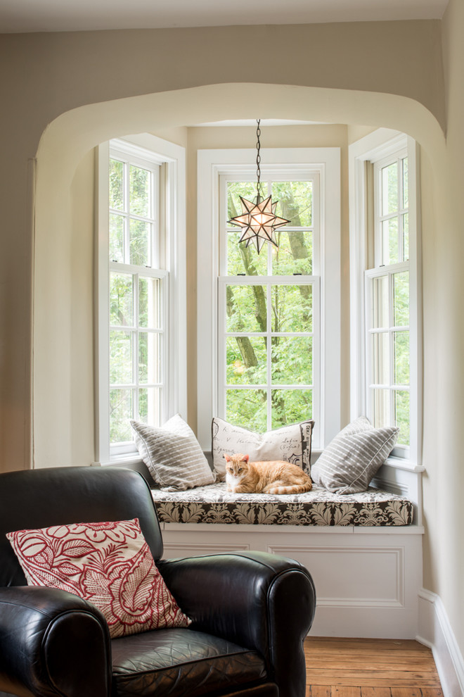 Elegant enclosed medium tone wood floor living room photo in Philadelphia with beige walls