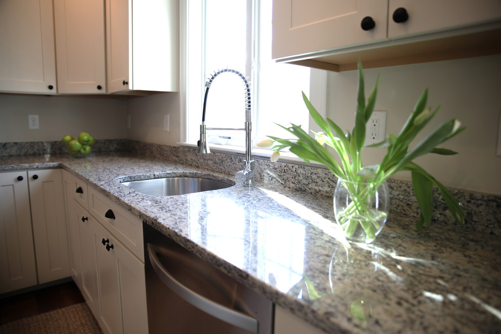 Transitional medium tone wood floor kitchen photo in Boston with granite countertops and an island