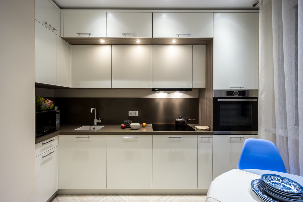 This is an example of a mid-sized contemporary l-shaped separate kitchen in Moscow with a single-bowl sink, flat-panel cabinets, white cabinets, quartz benchtops, brown splashback, stone slab splashback, porcelain floors, no island, beige floor and stainless steel appliances.