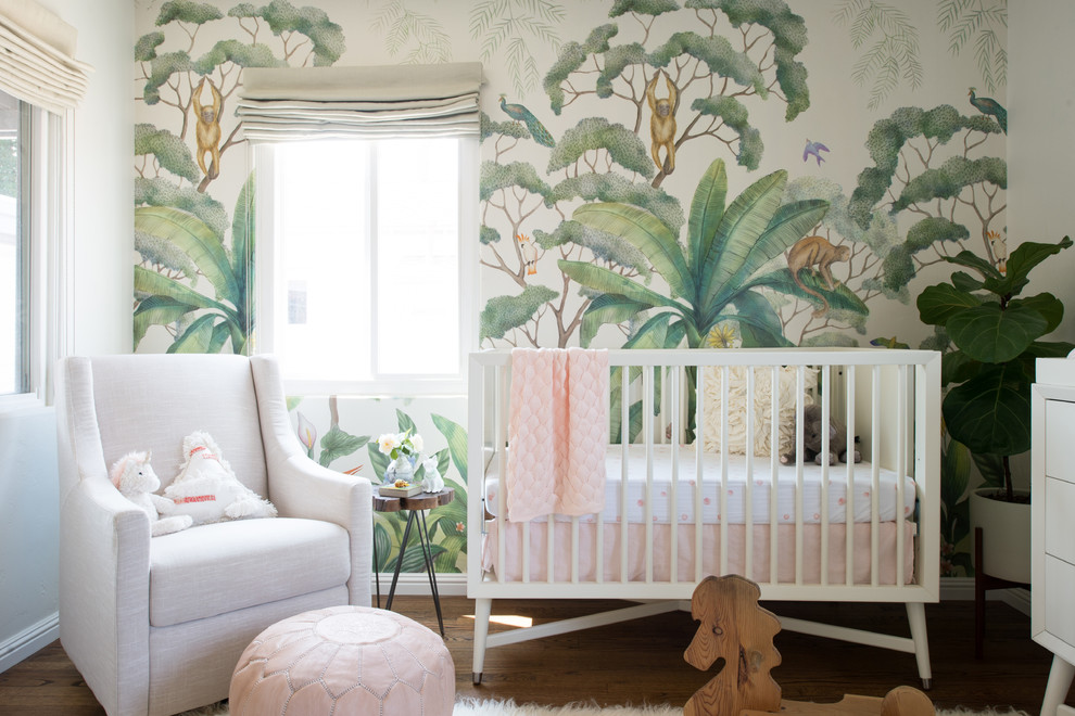 Design ideas for a mid-sized eclectic nursery for girls in San Diego with medium hardwood floors.
