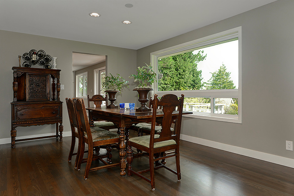 This is an example of a transitional dining room in Seattle with grey walls and medium hardwood floors.