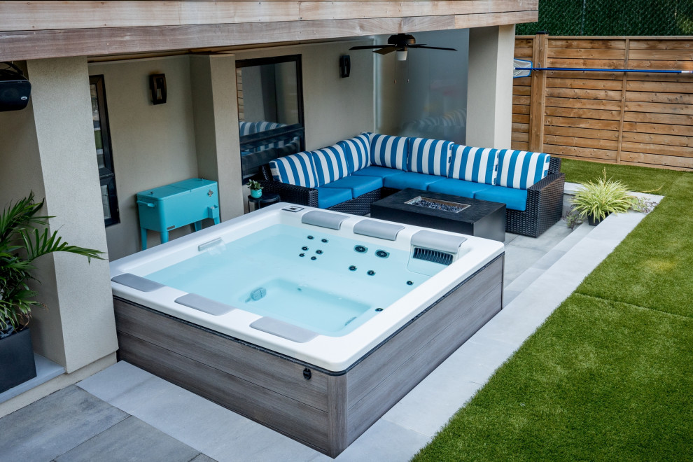 Design ideas for a small transitional backyard rectangular pool in Toronto with a hot tub and concrete pavers.