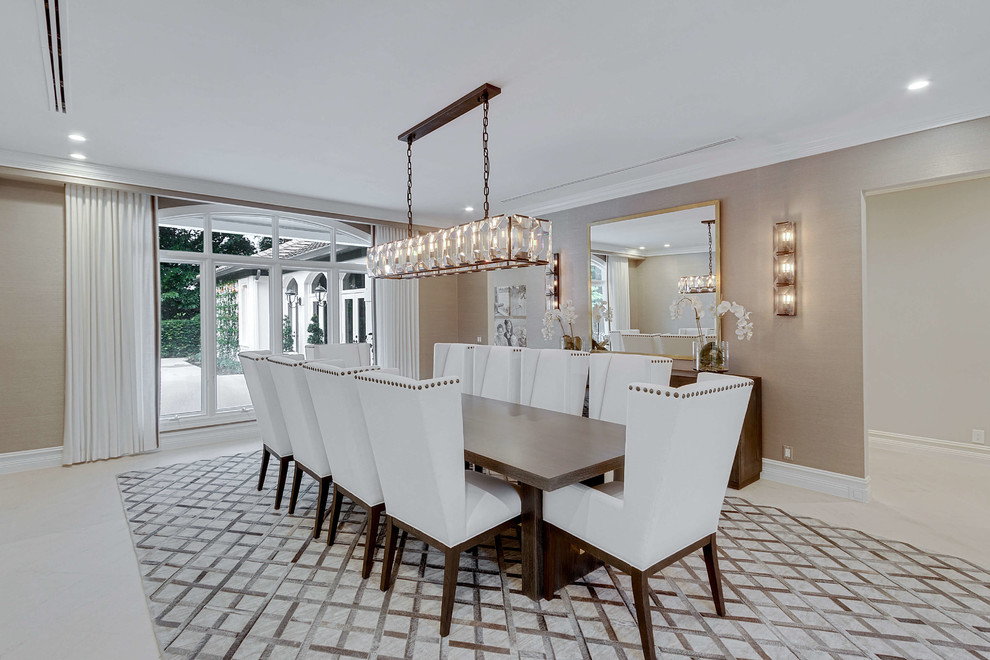 Photo of a mid-sized transitional open plan dining in Miami with beige walls, concrete floors, no fireplace and white floor.