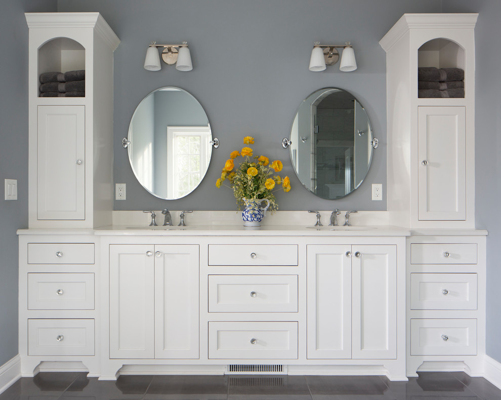 Mid-sized arts and crafts master bathroom in Milwaukee with flat-panel cabinets, white cabinets, a drop-in tub, an alcove shower, white tile, grey walls, porcelain floors, an undermount sink, engineered quartz benchtops, grey floor, a hinged shower door, white benchtops and marble.