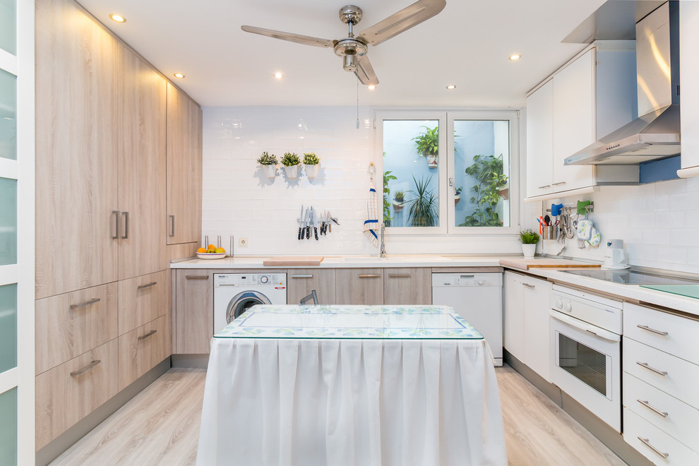Photo of a mid-sized mediterranean l-shaped eat-in kitchen in Other with flat-panel cabinets, white cabinets, white splashback, light hardwood floors and no island.
