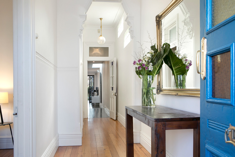 Arts and crafts hallway in Sydney with white walls, medium hardwood floors and brown floor.