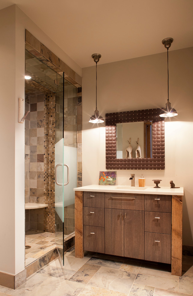 Photo of a country bathroom in Denver with flat-panel cabinets, dark wood cabinets, an alcove shower, multi-coloured tile and beige walls.