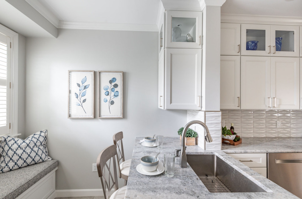 Inspiration for a small transitional u-shaped porcelain tile and gray floor enclosed kitchen remodel in Boston with an undermount sink, shaker cabinets, white cabinets, quartz countertops, gray backsplash, ceramic backsplash, stainless steel appliances and gray countertops
