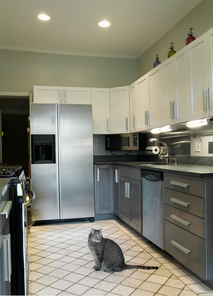 This is an example of a small transitional galley separate kitchen in Chicago with an undermount sink, shaker cabinets, grey cabinets, granite benchtops, grey splashback, metal splashback, stainless steel appliances, marble floors and no island.