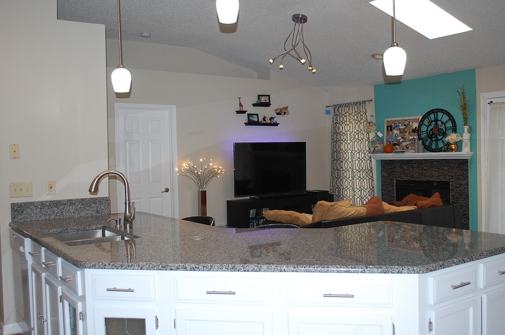 Example of a transitional u-shaped kitchen design in Jacksonville with shaker cabinets, white cabinets and granite countertops