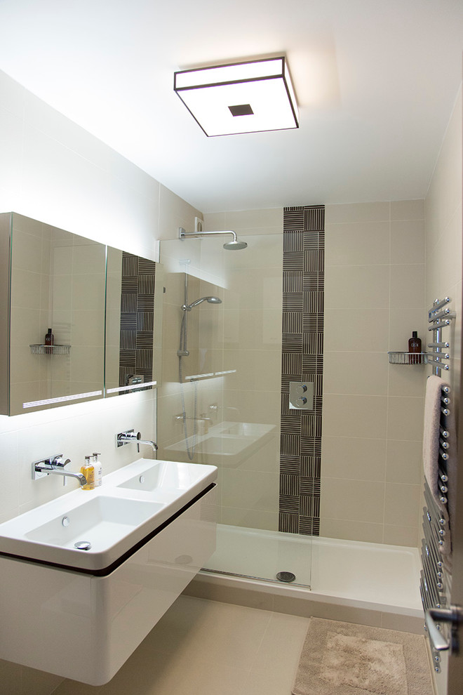 This is an example of a small contemporary master bathroom in London with an integrated sink, flat-panel cabinets, white cabinets, an open shower, beige tile, ceramic tile, ceramic floors, white walls and an open shower.