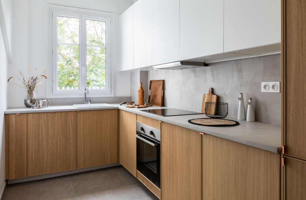 This is an example of a contemporary l-shaped separate kitchen in Paris with a drop-in sink, beaded inset cabinets, medium wood cabinets, concrete benchtops, grey splashback, panelled appliances, concrete floors, no island, grey floor and grey benchtop.