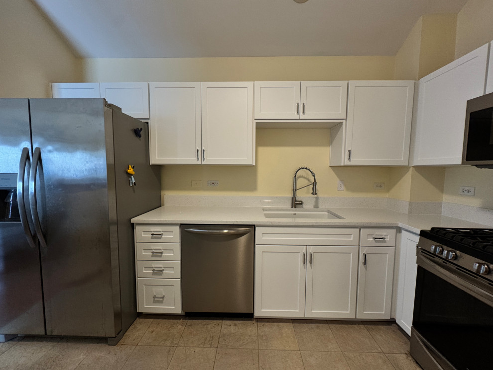 Inspiration for a mid-sized transitional l-shaped enclosed kitchen remodel in Chicago with shaker cabinets, white cabinets, quartz countertops and white countertops