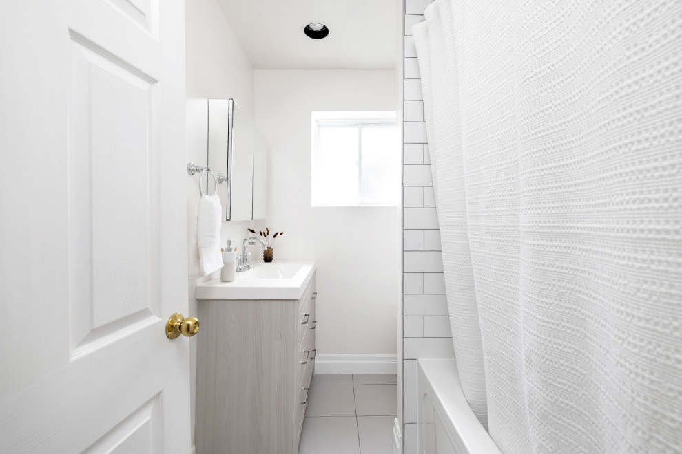 Inspiration for a small contemporary bathroom in Toronto with flat-panel cabinets, grey cabinets, an alcove tub, white tile, porcelain tile, white walls, terra-cotta floors, an integrated sink, grey floor, white benchtops, a single vanity and a built-in vanity.