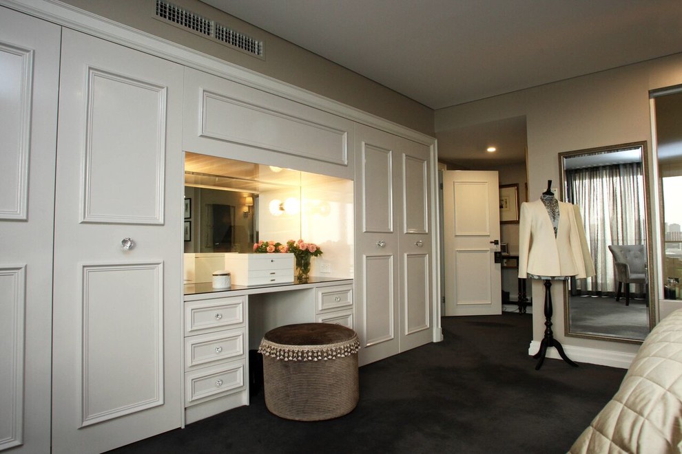 Design ideas for a large transitional master bedroom in Melbourne with beige walls and carpet.