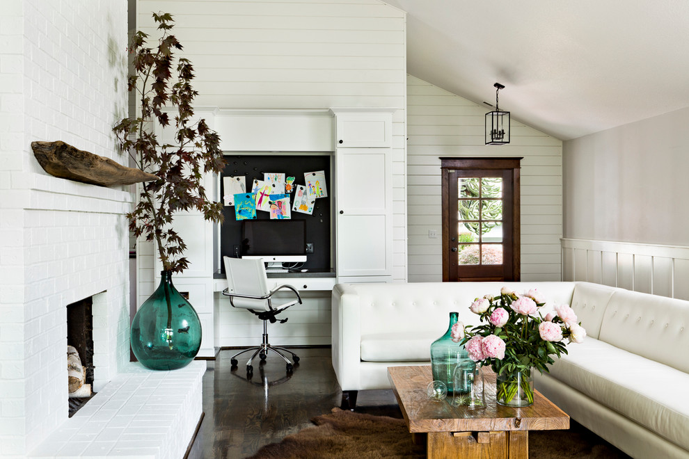 This is an example of a transitional living room in Portland with white walls.