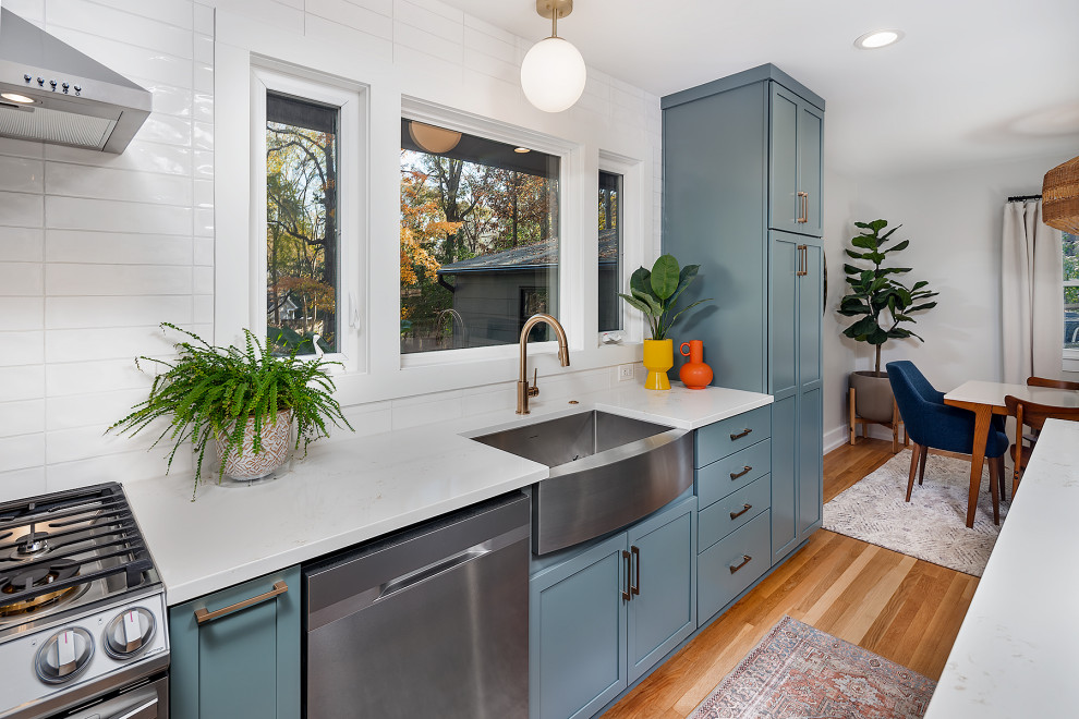 This is an example of a large midcentury l-shaped eat-in kitchen in Charlotte with an undermount sink, shaker cabinets, turquoise cabinets, marble benchtops, white splashback, stainless steel appliances and with island.