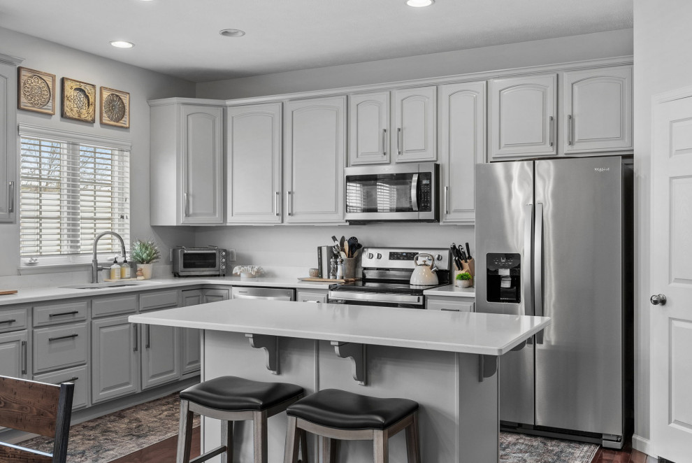Eat-in kitchen - transitional dark wood floor eat-in kitchen idea with a double-bowl sink, gray cabinets, quartz countertops, stainless steel appliances, an island and white countertops