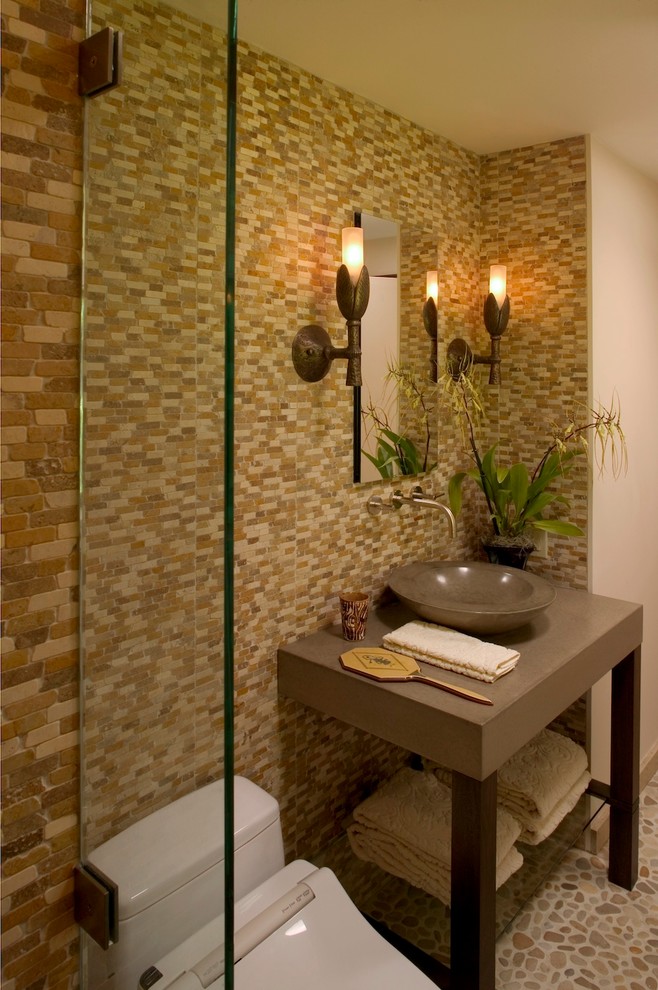 Inspiration for a mid-sized asian 3/4 bathroom in San Francisco with a vessel sink, concrete benchtops, brown tile and stone tile.