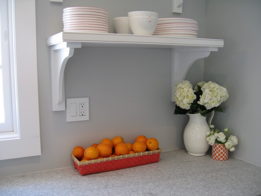 Transitional slate floor eat-in kitchen photo in New York with a farmhouse sink, recessed-panel cabinets, white cabinets and paneled appliances