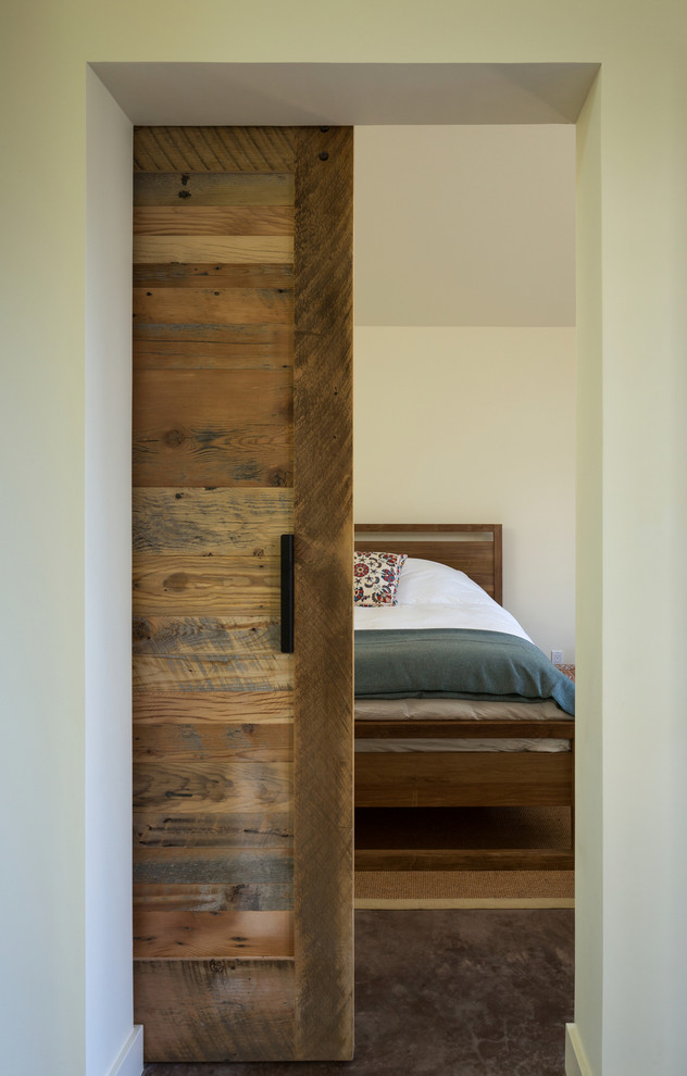 Design ideas for a small traditional master bedroom in San Francisco with white walls, concrete floors and no fireplace.